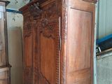 a large wooden armoire in a room with a blue ceiling