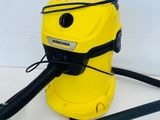 a yellow and black vacuum on a white surface