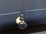 a car key hanging from a wire with a nissan logo on it