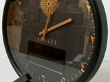 a clock that is sitting on a stand with a clock on it