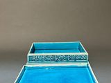 two blue trays sitting on top of each other on a table