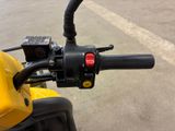 a close up of the handlebars on a yellow motorcycle