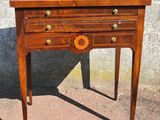 a small wooden table with a drawer on top of it