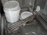 a white bucket sitting inside of an oven with the door open