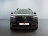 the front view of a black citrole parked in a white room