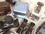 a lot of old cameras and other items on the table