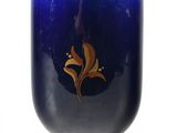 a blue vase with a gold rim sitting on a white surface