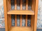 a small wooden shelf with two shelves on it