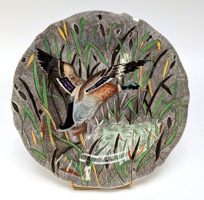 a decorative plate with a bird on it on a white background