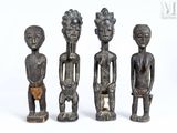 three carved wooden figures of men standing next to each other