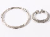 a close up of two silver rings on a white surface