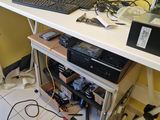a computer desk with a monitor, keyboard, mouse and other electronics on it