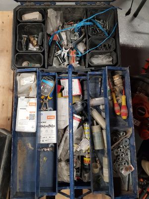 a blue tool box filled with assorted tools on a table