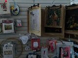 many pictures hanging on the wall of a store
