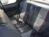 a seat in the back of a car with red trims