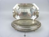 an antique silver plate with a mirror on top of it