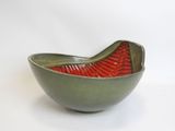 a green bowl with a red design on it