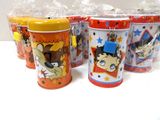 several tins with cartoon characters are lined up on a table