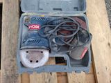 a tool box with a corded sander and other tools in it