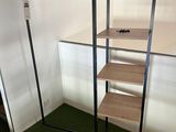 a shelf that has a shelf on it in the corner of a room