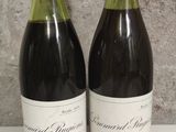 two bottles of wine sitting next to each other on a table