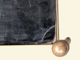 a blackboard on a wall with a gold ball on it