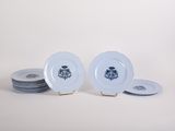 several white plates with blue designs are stacked on top of each other