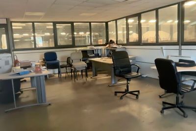 a room with a lot of desks and chairs in it
