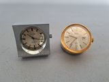 a silver and gold clock and a silver and gold watch