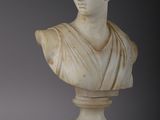 a white marble bust of a woman on a pedestal