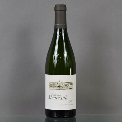 a bottle of wine sitting on top of a table next to a glass