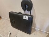 a piece of luggage sitting on the floor next to a bike