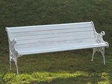 a white bench sitting in the middle of a grassy field