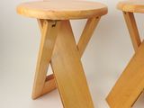 pair of wooden stools with wooden legs on a white background