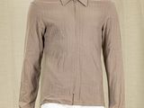 a mannequin wearing a brown shirt and white pants