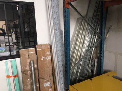 a yellow table in the middle of a room filled with boxes