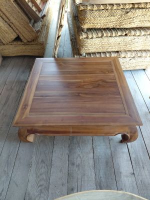 a wooden table with a square top on a wooden floor