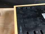 someone is using a screwdriver to remove the screws from the base of a wooden box