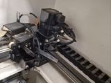 an image of a machine that is working on a piece of metal