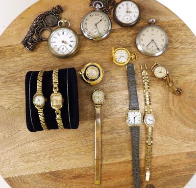 many different types of watches and bracelets on a wooden table
