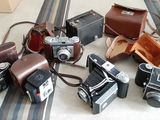 a lot of old cameras sitting on a table