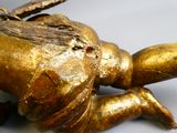a gold statue of a turtle with a leaf on it ' s back