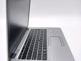 a close up of a laptop computer on a white surface