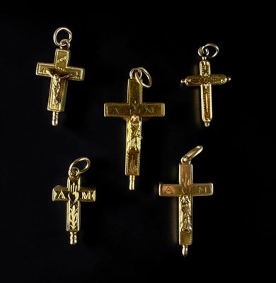 four gold crosses are shown on a black surface