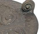 a close up of a metal object on a white surface