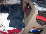 a box full of clothes sitting on the floor