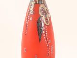 a red vase with a design on it on a white background