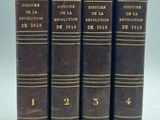 a set of four books sitting on top of each other