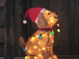 a teddy bear wearing a santa claus hat and lights
