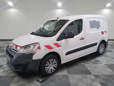 the white van is parked on a checkered floor in the garage